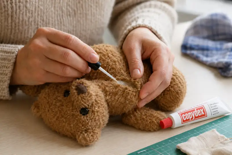 Applying Copydex adhesive with a fine dropper applicator for precise craft repairs UK