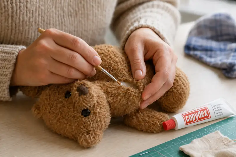Copydex adhesive mending a teddy bear seam soft toy repair UK